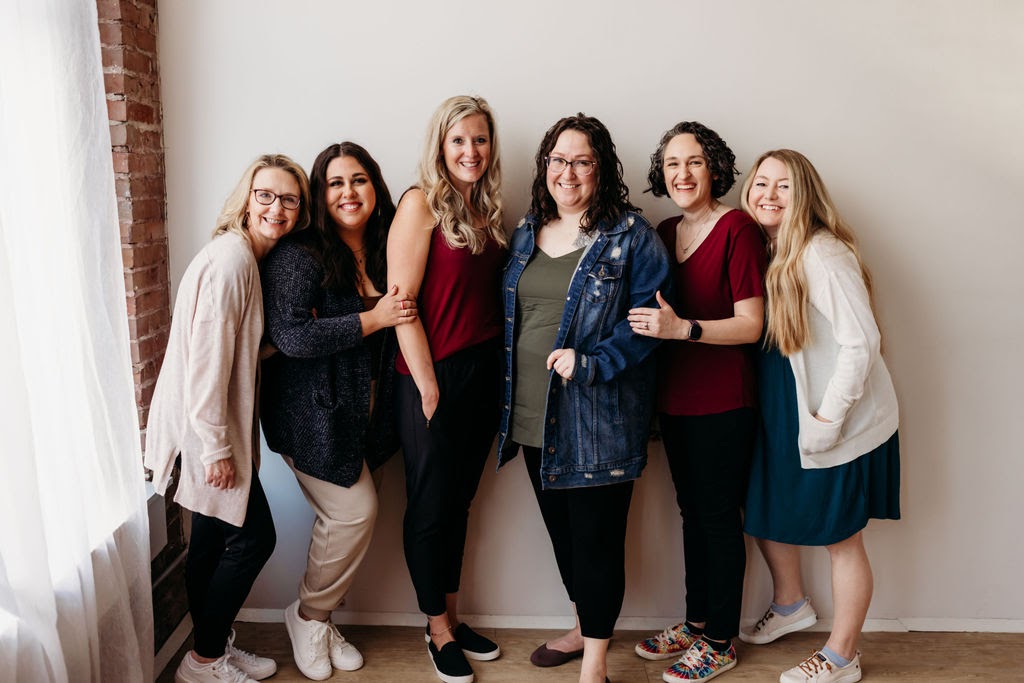 All of the women of Welcome Baby KC smiling at the camera