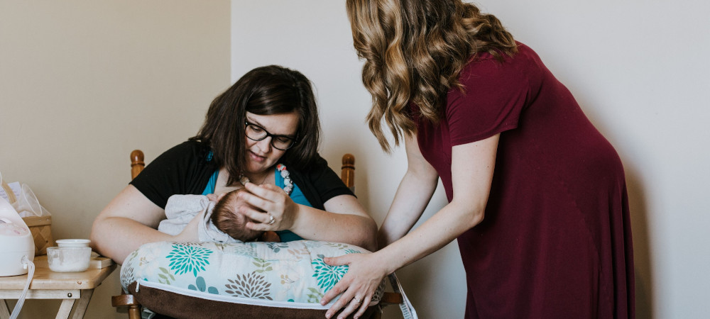 A mother recieving breast feeding support from a lactation educator