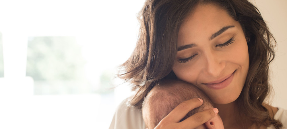 A woman holding her baby